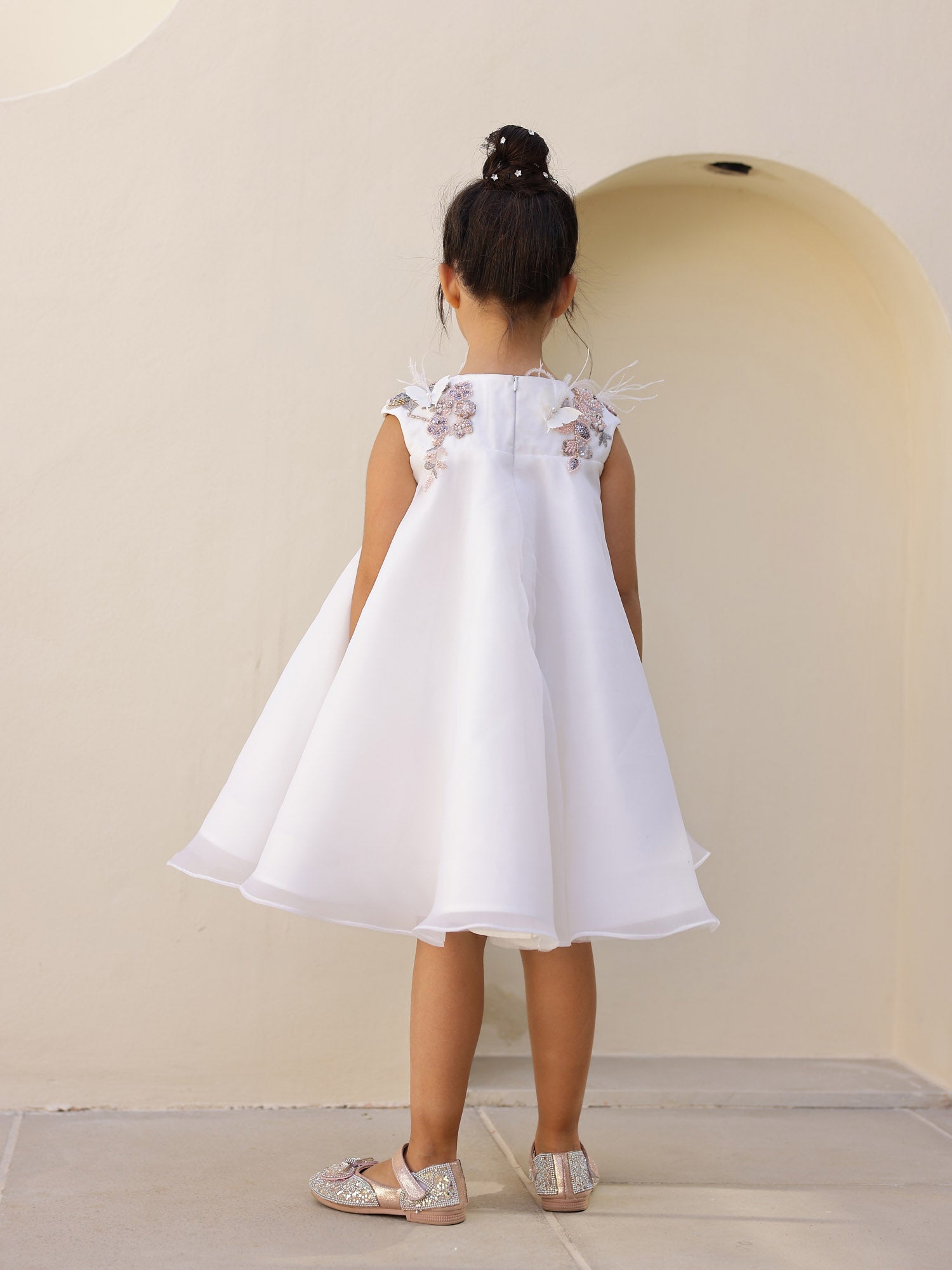 Back view of white twirl-ready children’s party dress