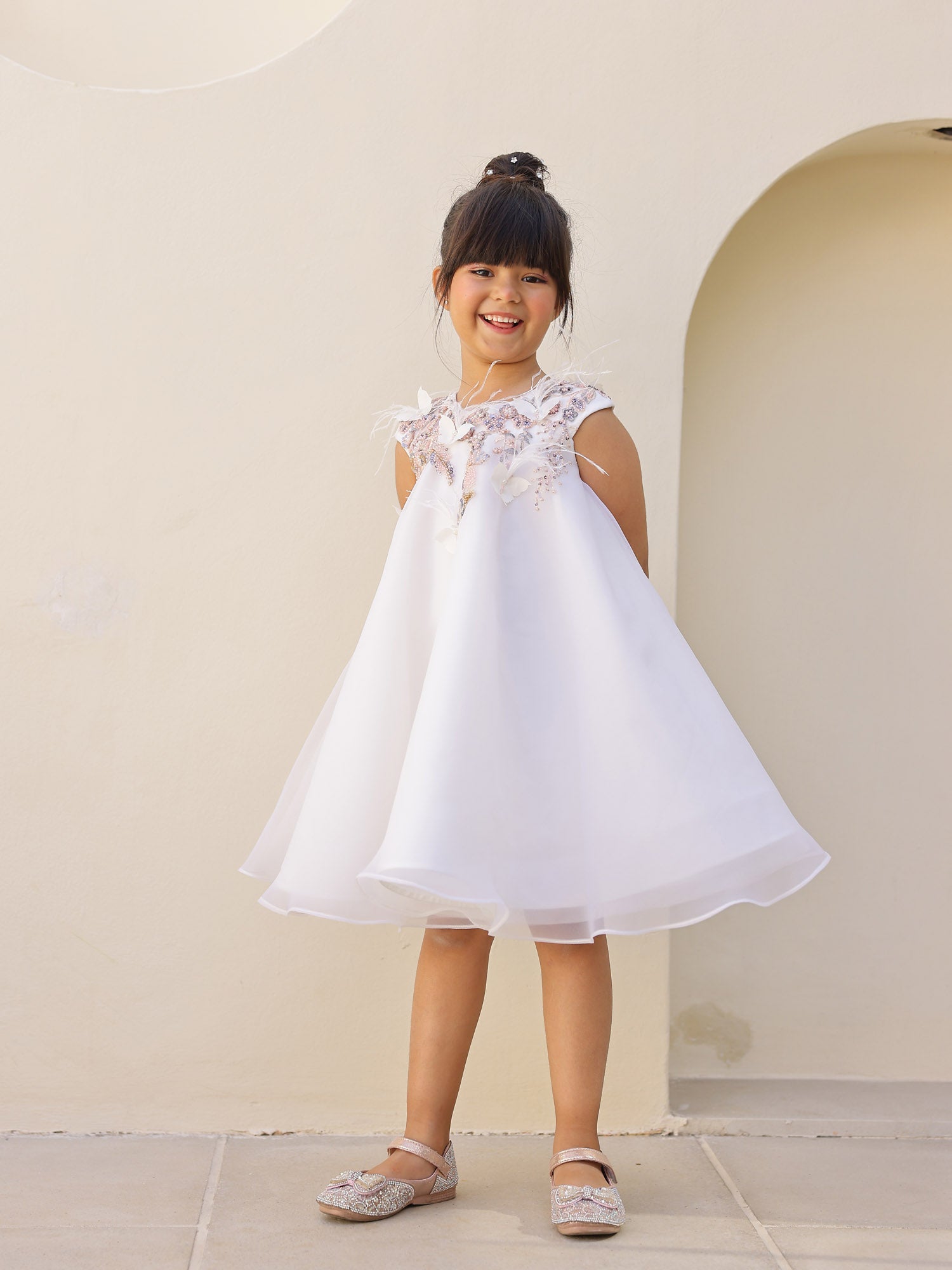 Side angle of white embroidered kids A-line dress