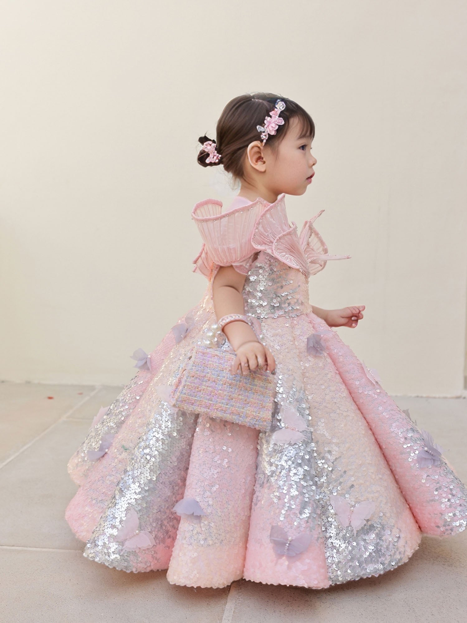 A stunning pink sequin gown with an ombre shine, wired neckline, and butterfly motifs—designed for birthdays and special celebrations.