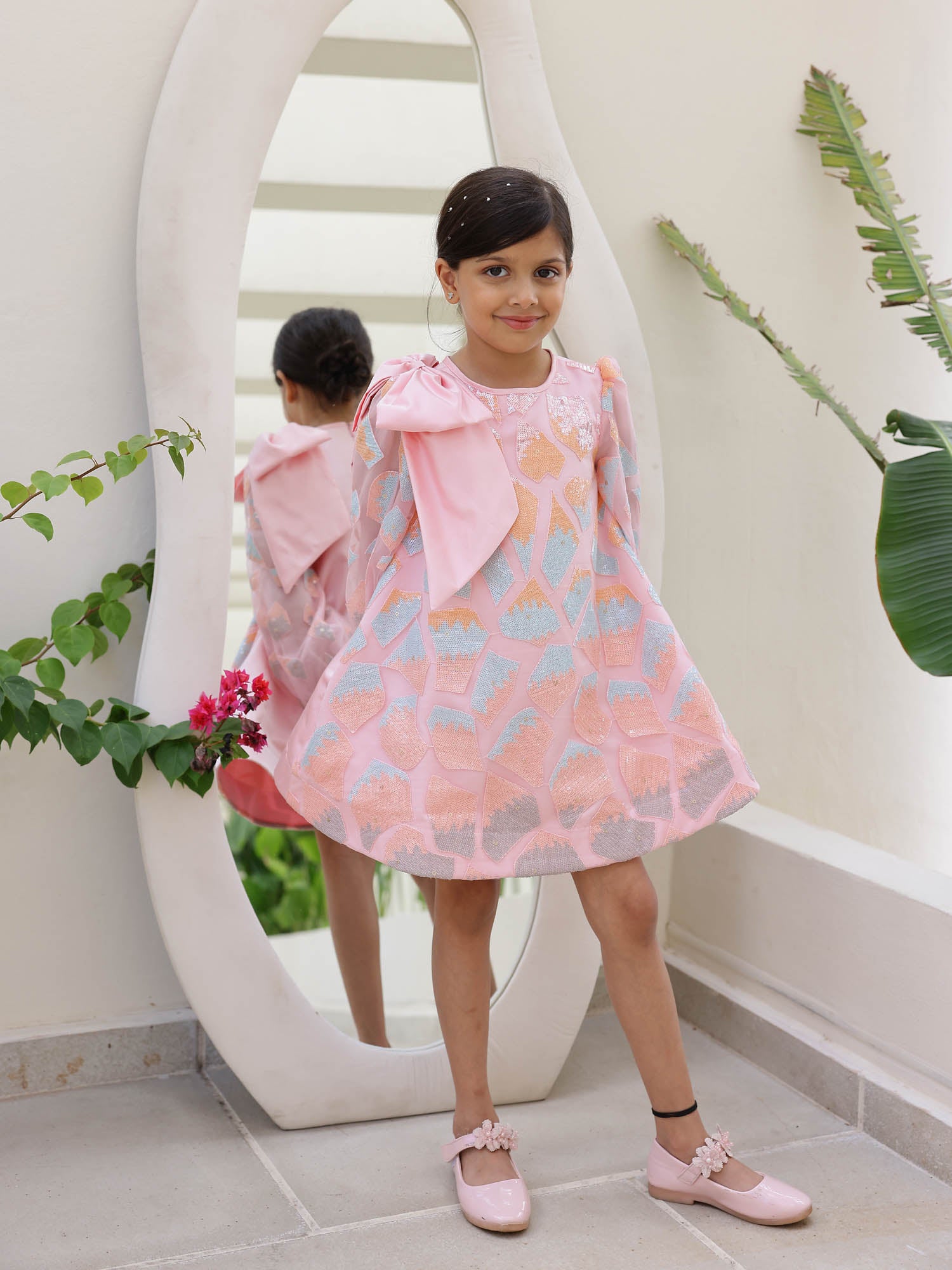 Girls' A-Line party dress with abstract block sequins and bow detail.