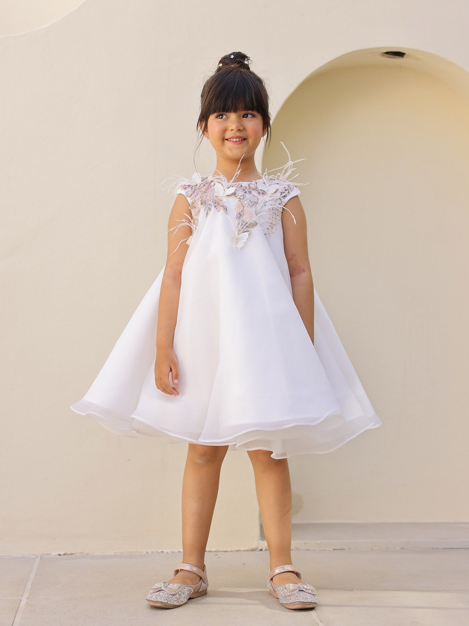 Front view of white A-line embroidered kids dress